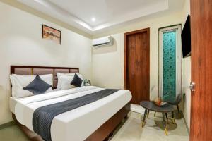 a hotel room with a bed and a window at Hotel Ivory Delhi Airport in New Delhi