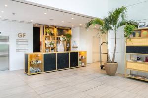 a store with a palm tree in the middle of a room at INNSiDE by Meliá Milano Torre GalFa in Milan