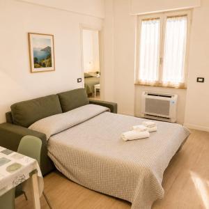 a bedroom with a bed and a couch at Bolle Apartment Monterosso al mare in Monterosso al Mare