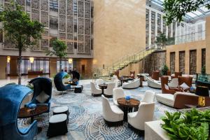 a hotel lobby with a slide and chairs and tables at Intercontinental Jinan City Center by IHG in Jinan