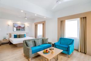 a living room with a couch and a bed at Red Fox by Lemon Tree Hotels, Sector 60, Gurugram in Gurgaon +21 photos