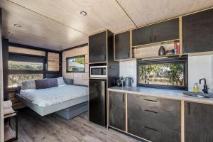 a kitchen with a bed in a caravan at Trackside Tiny Home in Augusta
