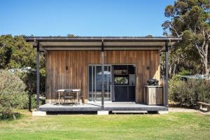 a small cabin with a table in a yard at Trackside Tiny Home in Augusta