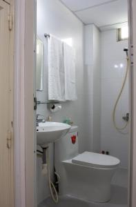 a white bathroom with a sink and a toilet at QUANG SAIGON Hotel- 40-7 Bùi Viện-Walking street in Ho Chi Minh City +72 photos