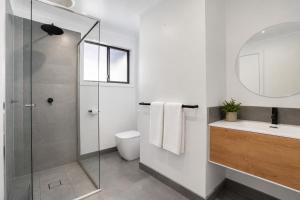 a bathroom with a shower and a toilet and a sink at Solander in Dromana with Private Spa by Ready Set Stay in Dromana