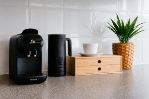 a coffee maker sitting on a counter next to a cup at Solander in Dromana with Private Spa by Ready Set Stay in Dromana +14 photos