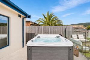 a hot tub on the patio of a house at Solander in Dromana with Private Spa by Ready Set Stay in Dromana