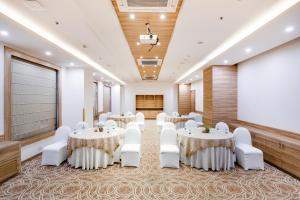 a conference room with tables and chairs and a screen at Lemon Tree Hotel, Sector 60, Gurugram in Gurgaon +35 photos