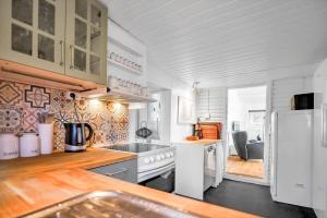a white kitchen with a sink and a refrigerator at 14231-1-Grevinge-Kirsebaerhaven-18 in Grevinge