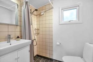 a bathroom with a sink and a toilet and a window at 14231-1-Grevinge-Kirsebaerhaven-18 in Grevinge +19 photos