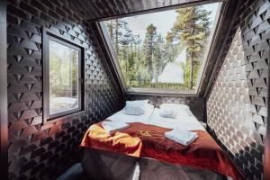 a small room with a bed in a brick wall at Aurora Village Ivalo in Ivalo