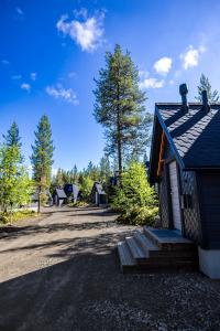 a small building with a porch on a dirt road at Aurora Village Ivalo in Ivalo