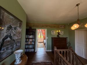 a living room with a large painting on the wall at La Grange Terrou in Saint-Germain-de-Confolens