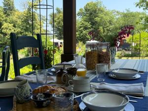 a table with a blue table cloth with food on it at La Grange Terrou in Saint-Germain-de-Confolens