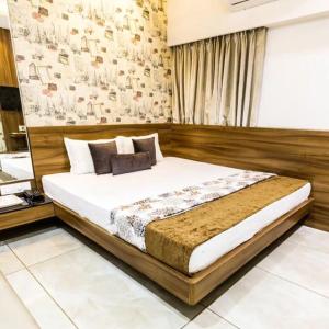 a bedroom with a large bed in a room at Hotel Rockland Kota in Kota