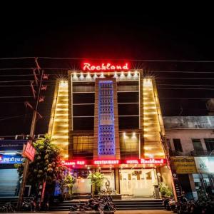 a hotel with a neon sign on the front of it at Hotel Rockland Kota in Kota