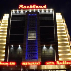 a hotel building with a blue lit up tower at Hotel Rockland Kota in Kota +7 photos