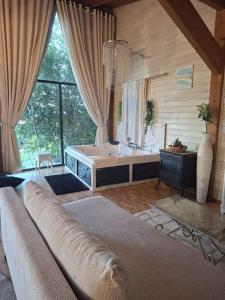 a large bathroom with a tub and a large window at צימר תומר דבורה-קצה ההר in Kerem Ben Zimra