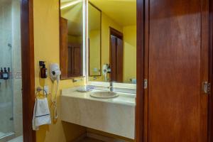 a bathroom with a sink and a mirror at Hotel Casa Santa Lucia in Zacatecas +62 photos