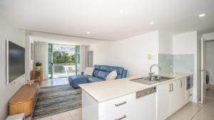 a kitchen and living room with a couch and a sink at Whispering Waves On Boyd in Woorim