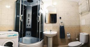 a bathroom with a shower and a sink and a toilet at Magnetic Studio Odkryta in Warsaw