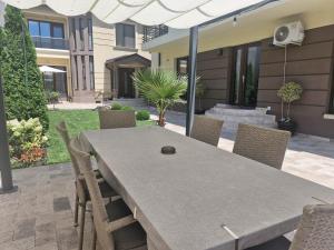 a table and chairs in a yard with a house at VILA MRV in Constanţa