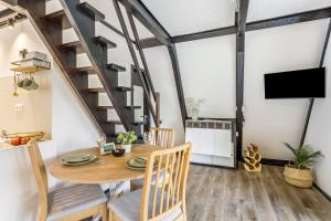 a dining room with a wooden table and chairs at Tiny House Trudi mit Garten in Bad Wünnenberg
