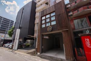 a building with a door open on a street at Danran HAKATA in Fukuoka