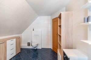 a bathroom with a toilet and a sink at Ferienwohnung Glück In Dornum in Dornum +14 photos