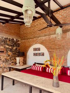 a room with a red couch and a brick wall at Palace Bope Galle in Galle
