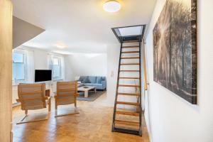 a room with a staircase and a living room at Ferienwohnung Glück In Dornum in Dornum