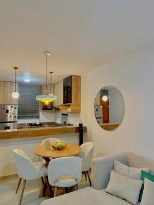 a kitchen and living room with a table and chairs at CasaLoop in Ica +8 photos