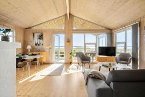 a living room with a couch and a table at FJ1601-Jaegerspris-Strandleddet-25 in Jægerspris