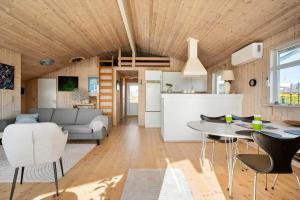 a living room with a couch and a table at FJ1601-Jaegerspris-Strandleddet-25 in Jægerspris +12 photos