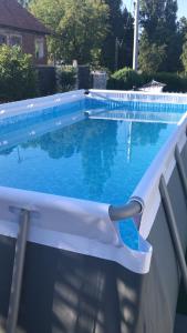 a swimming pool with a chair next to it at Casa De Sub Deal in Densuş
