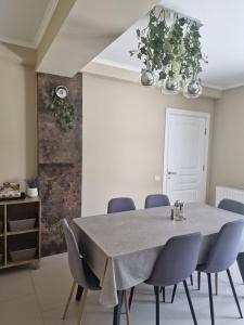 a dining room with a table and blue chairs at VILA MRV in Constanţa +43 photos
