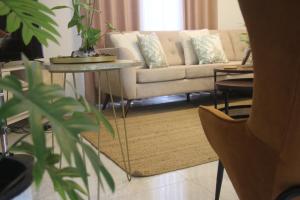 a living room with a couch and a table at Kavis Home in Ekalakurunduwatta