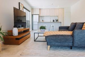 a living room with a couch and a table at 201 - Ocean Views Oceanfront Large Balcony in Suva
