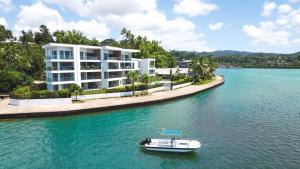 a boat in the water in front of a building at 201 - Ocean Views Oceanfront Large Balcony in Suva