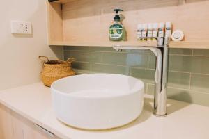 a kitchen counter with a sink and a faucet at 201 - Ocean Views Oceanfront Large Balcony in Suva +26 photos