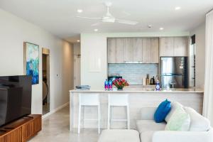 a living room with a couch and a kitchen at 307 - Suva City Views Oceanfront Large Balcony in Suva