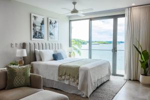 a bedroom with a large bed and a large window at 307 - Suva City Views Oceanfront Large Balcony in Suva
