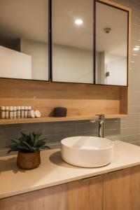 a bathroom counter with a sink and a mirror at 307 - Suva City Views Oceanfront Large Balcony in Suva +34 photos