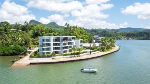 a building on an island in the water with a boat at 307 - Suva City Views Oceanfront Large Balcony in Suva