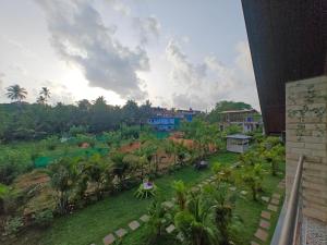 a person sitting on a table in a field with trees at Mermaid Avisa in Arambol