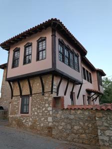 a building with black windows on a stone wall at Blue Marianthi in Ávdhira