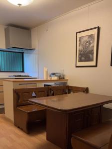 a kitchen with a table and a counter top at 薬医門の宿 in Katori