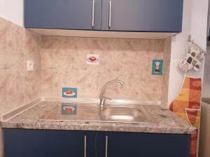 a kitchen with a sink and blue cabinets at Blue Marianthi in Ávdhira +31 photos