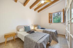 a bedroom with two beds and a couch at Villa Biniali Costitx in Costitx +26 photos