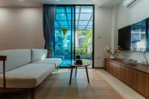 a living room with a couch and a tv at Caelistay in Hanoi